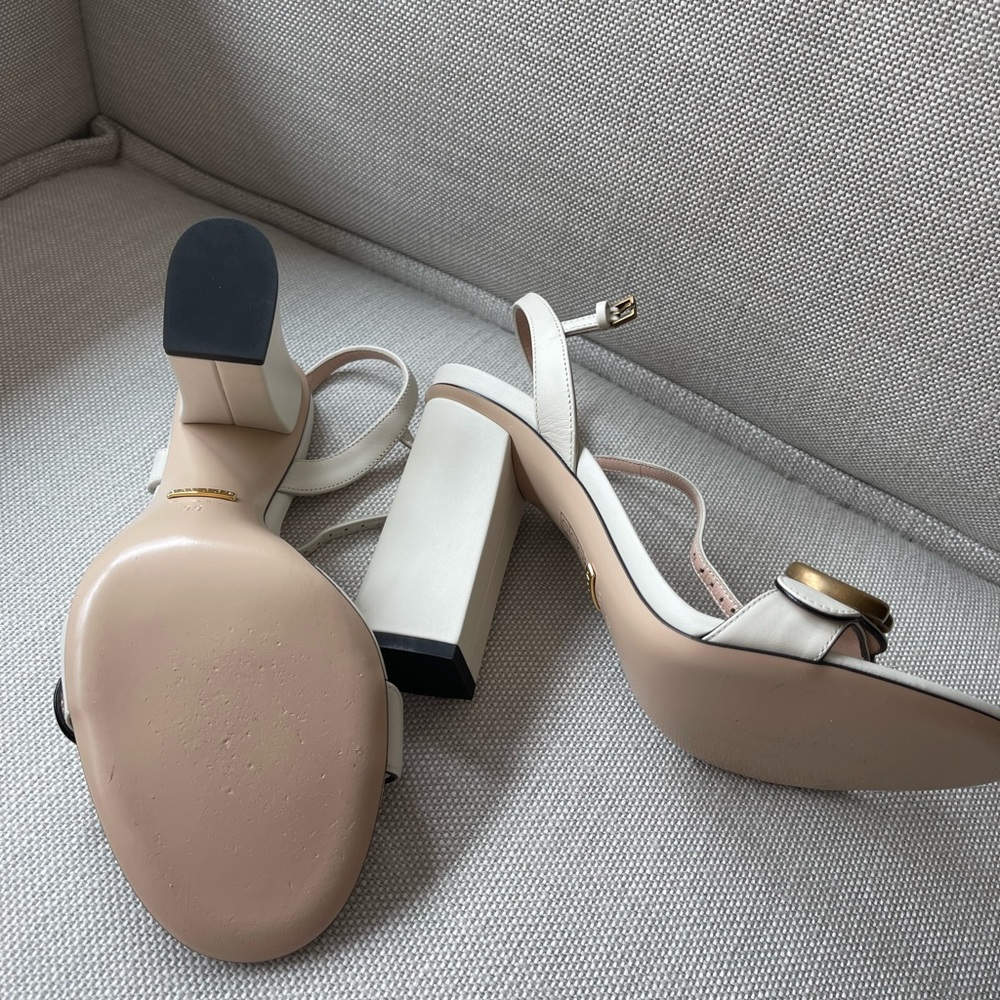 A thick heel balances these Gucci leather
sandals with a retro touch.